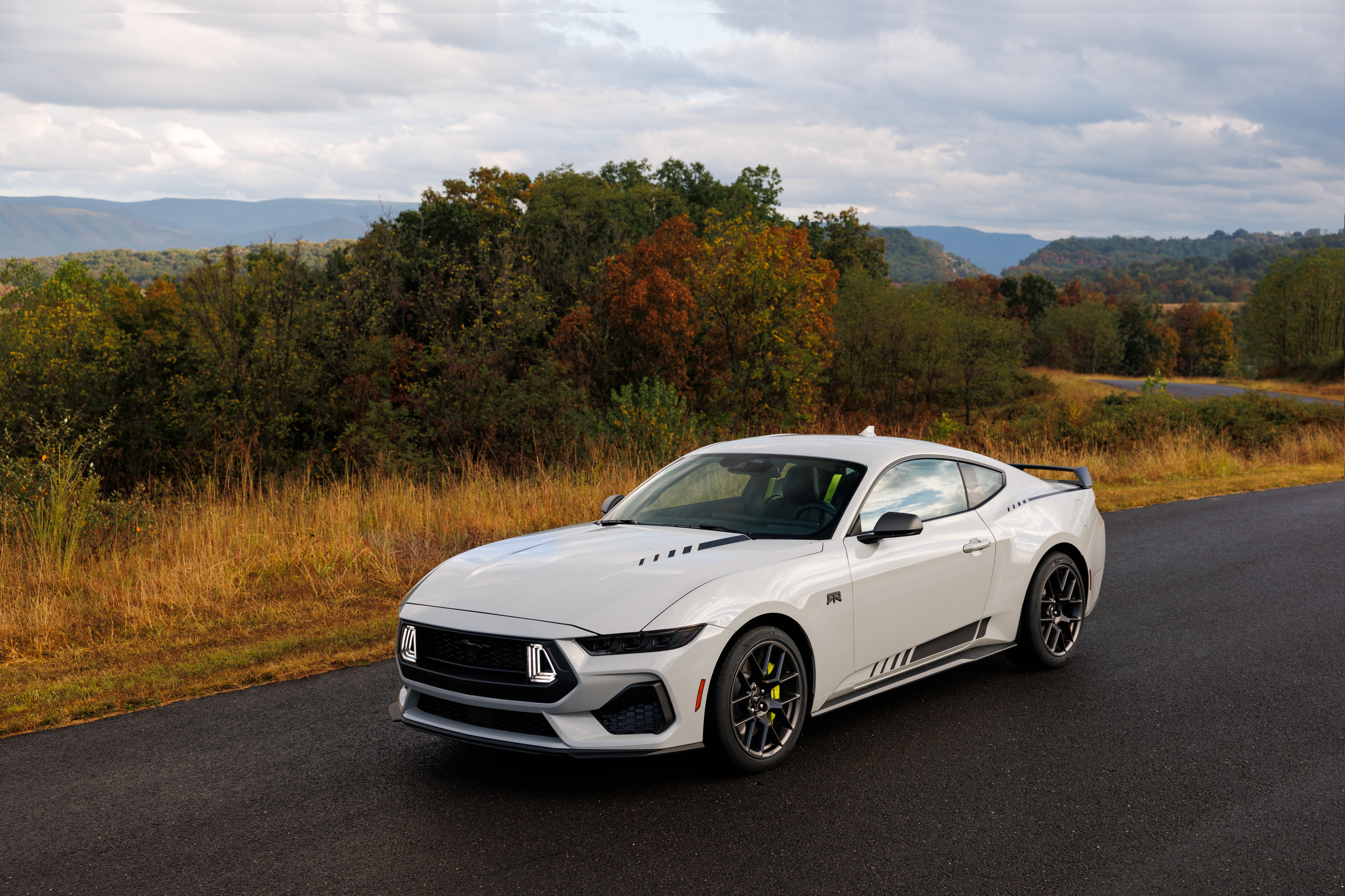 Optional RTR package available on 2026 Ford Mustang EcoBoost fastback. Preproduction model shown with optional Hyper Lime brake caliper shown. Available late spring 2026.